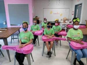 Members of the Embrace Girls Foundation wait to begin guitar lessons.