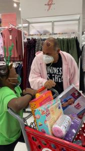 An Embrace Girls student ponders her Target shopping spree selections as Steven G looks on.