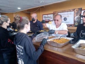 Steven G serves the homeless at Embrace Thanksgiving fete.