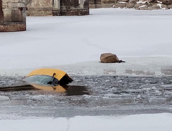 Whoops: Canadian Woman Stands On Top Of Car To Take Selfie After Driving It Into Frozen River. Local Residents Rescue Her