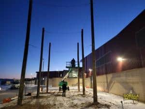 Crew members work into the evening hours installing CCIC's drone net enclosure.