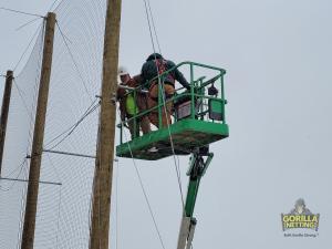 Netting gets installed on CCIC's new drone enclosure.