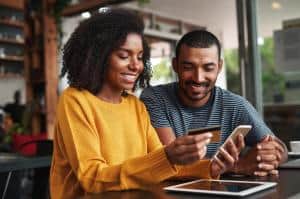 Couple paying their bill using a credit card and the Level 1 PCI Compliant 1800 Notify IVR Payment System